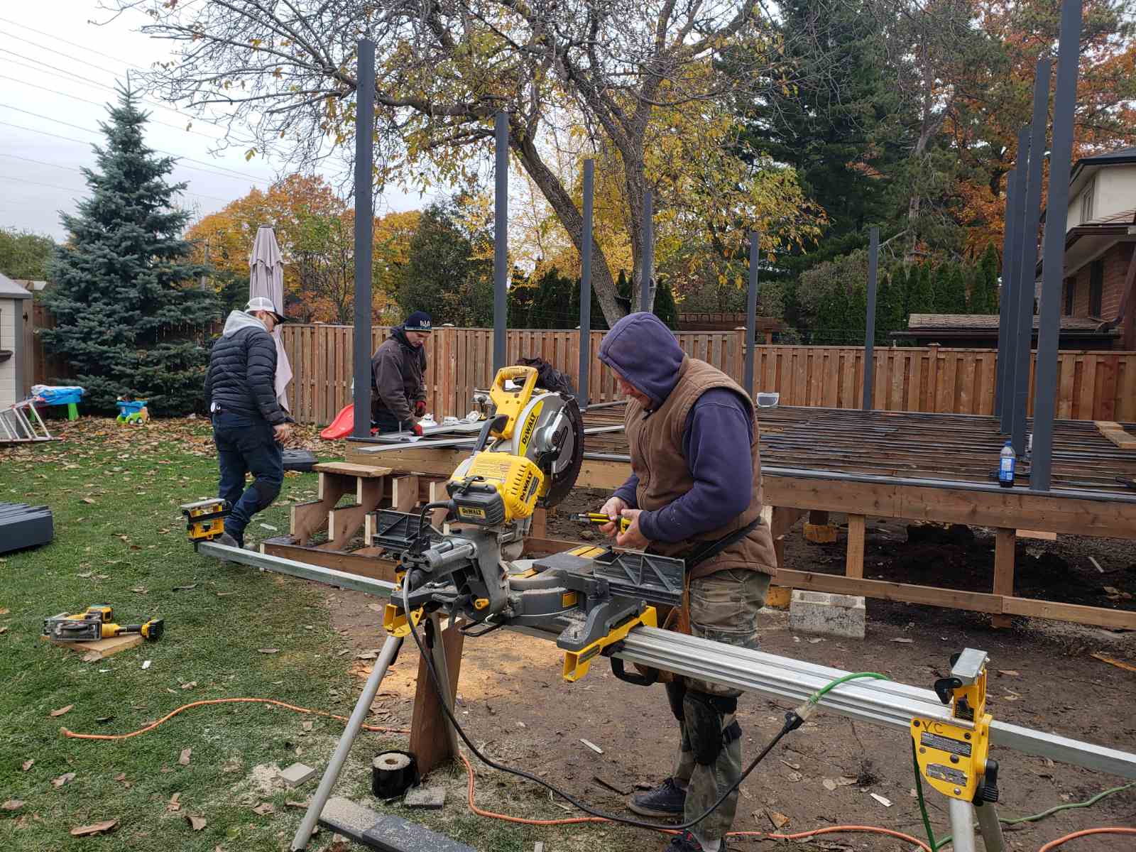 Ottawa deck builders working on pressure-treated wood deck framing